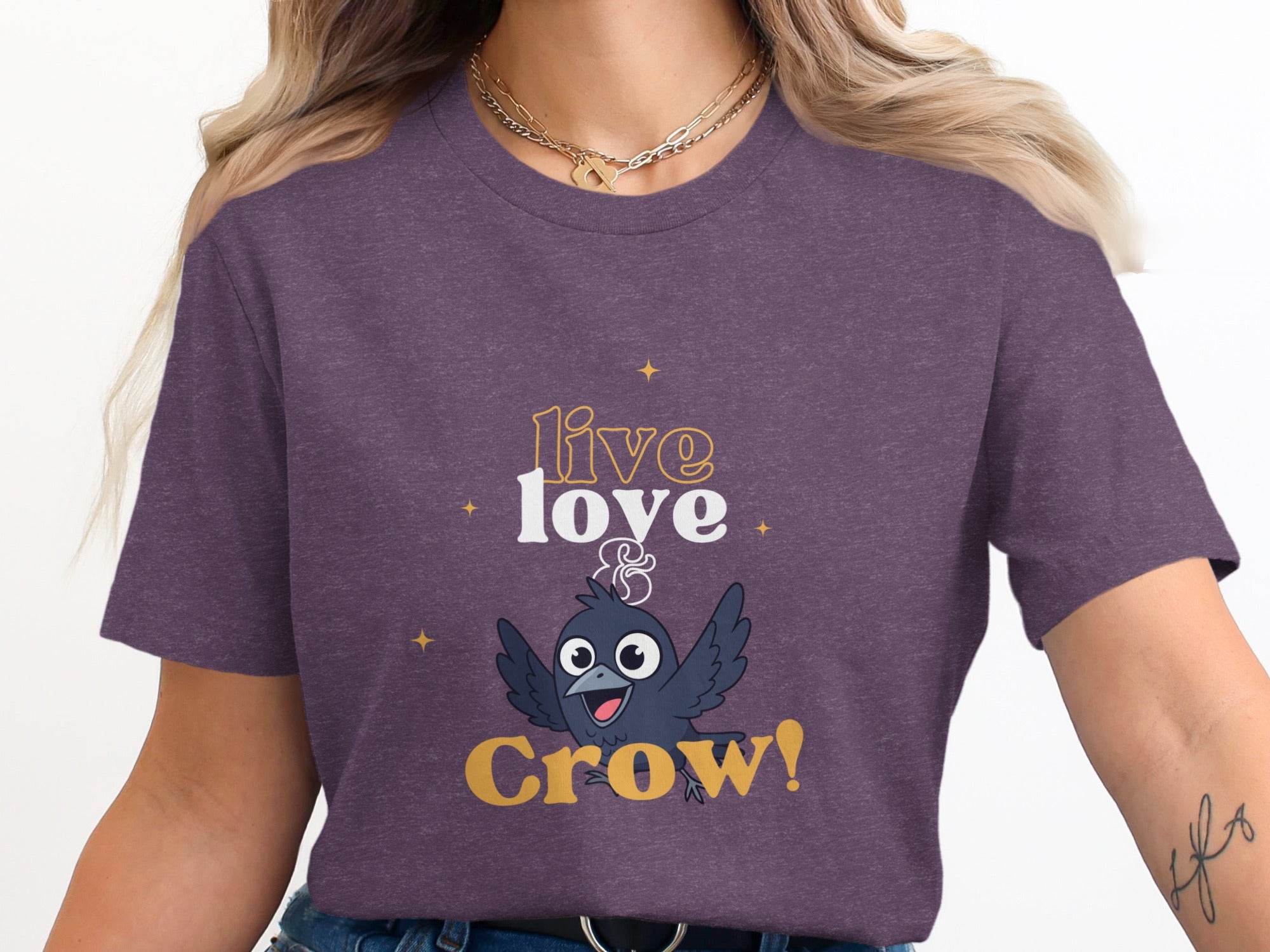 Purple t-shirt with a cartoon crow and the text "live & Crow!"