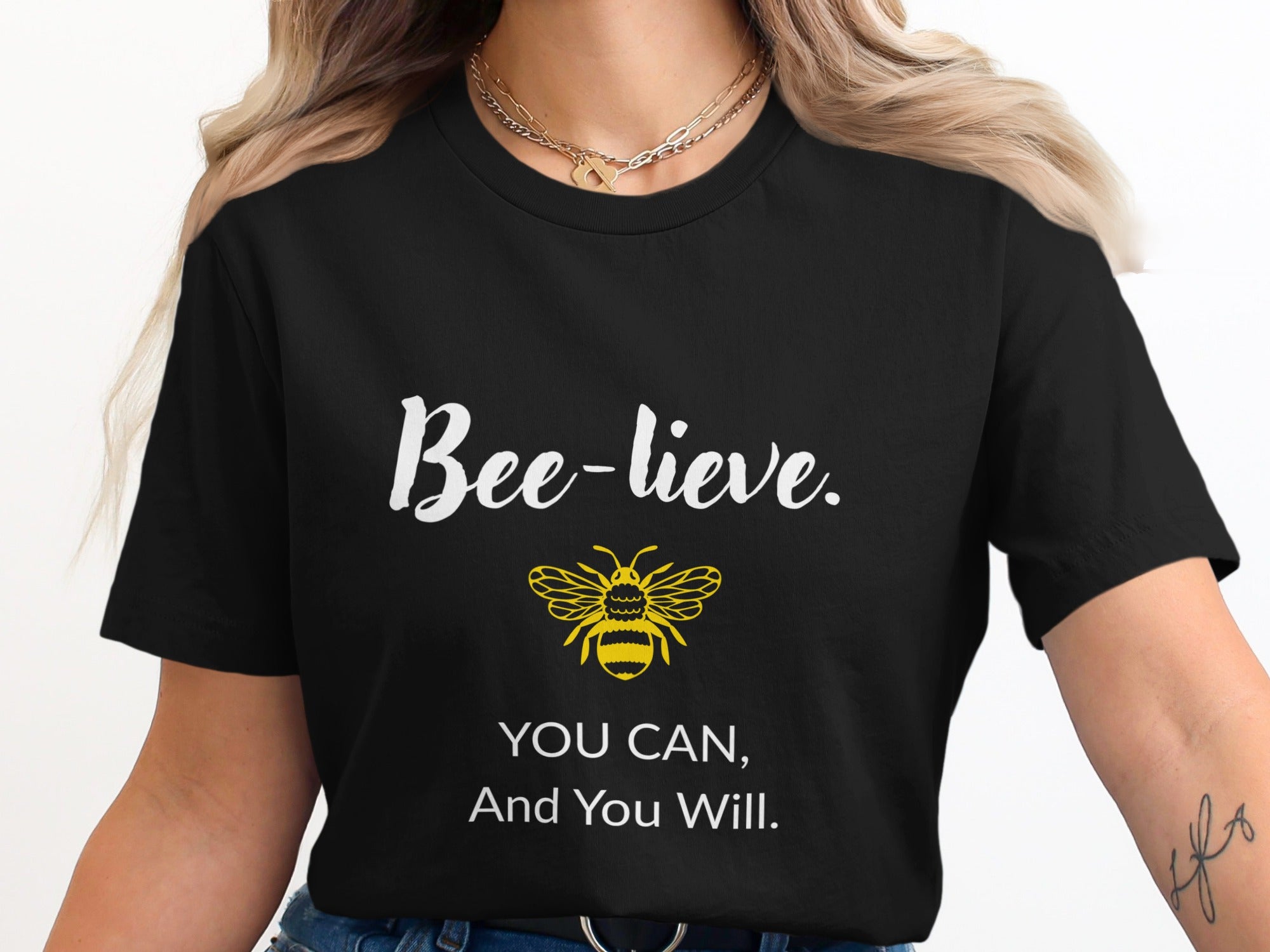 Black t-shirt with "Bee-lieve. You can, and you will." and a bee.