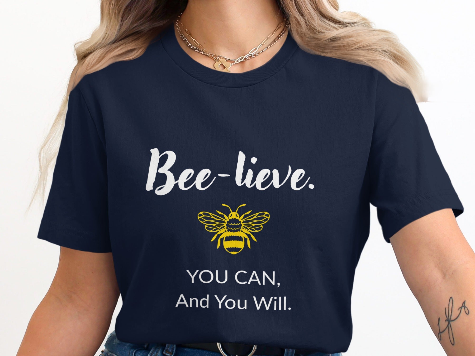 Navy t-shirt with "Bee-lieve. You can, and you will." and a bee graphic.