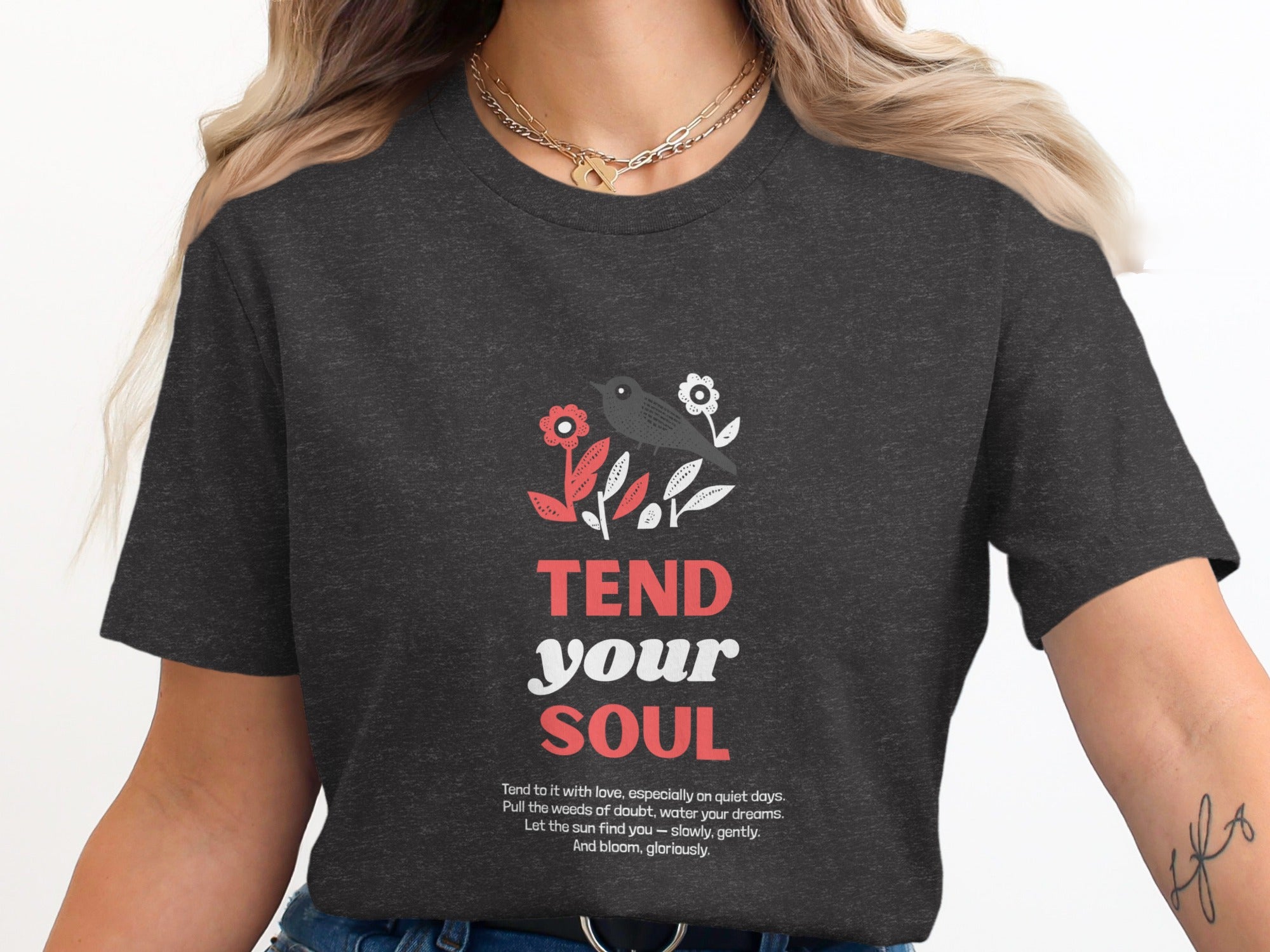 Dark t-shirt with "TEND your SOUL" text and floral design.
