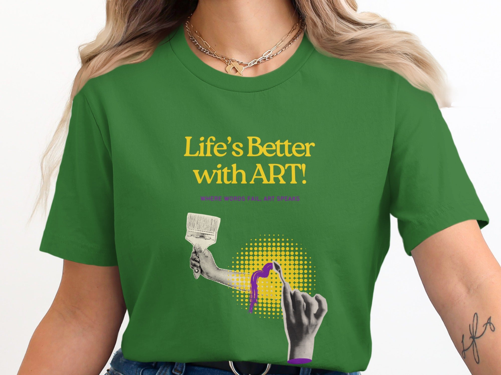 Green t-shirt with "Life's Better with ART!" text and hand holding paintbrush.