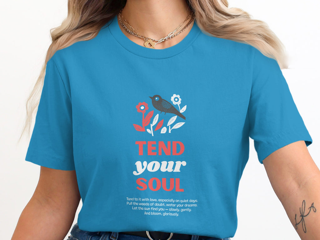 Blue t-shirt with "TEND your SOUL" text and floral bird design.