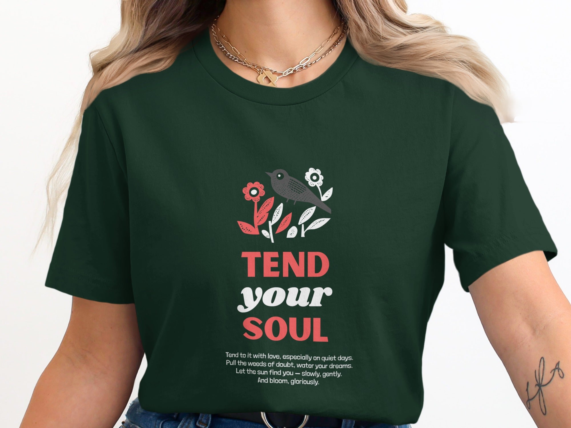 Dark green t-shirt with "Tend your soul" and floral bird graphic.