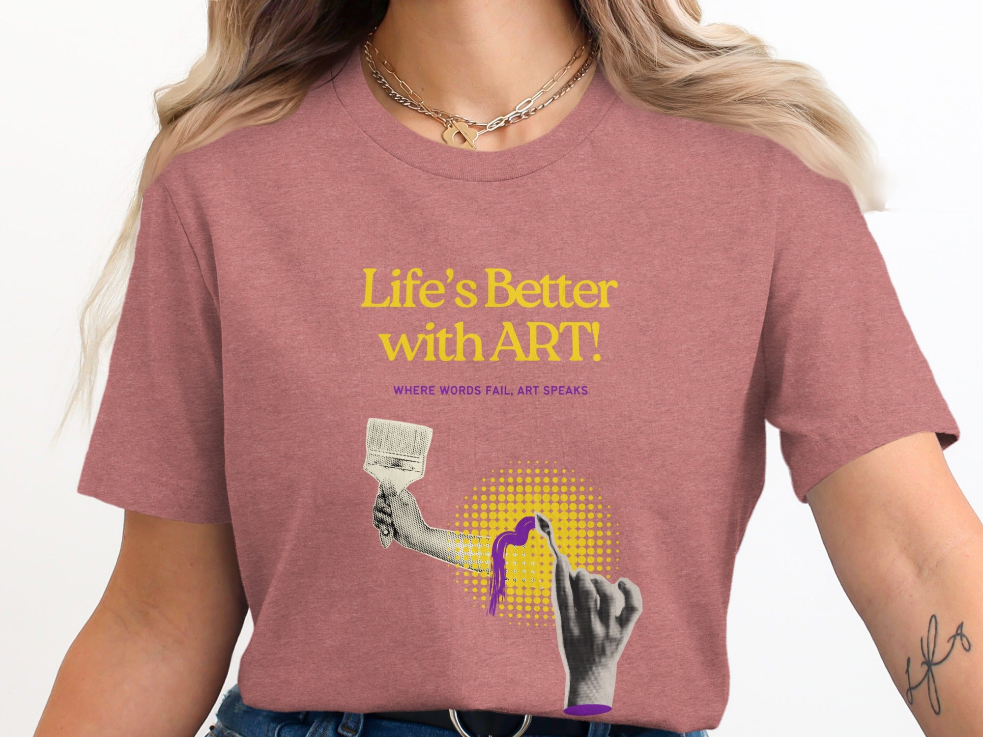 Woman wearing a pink t-shirt with "Life's Better with ART!" and paint brush graphic.