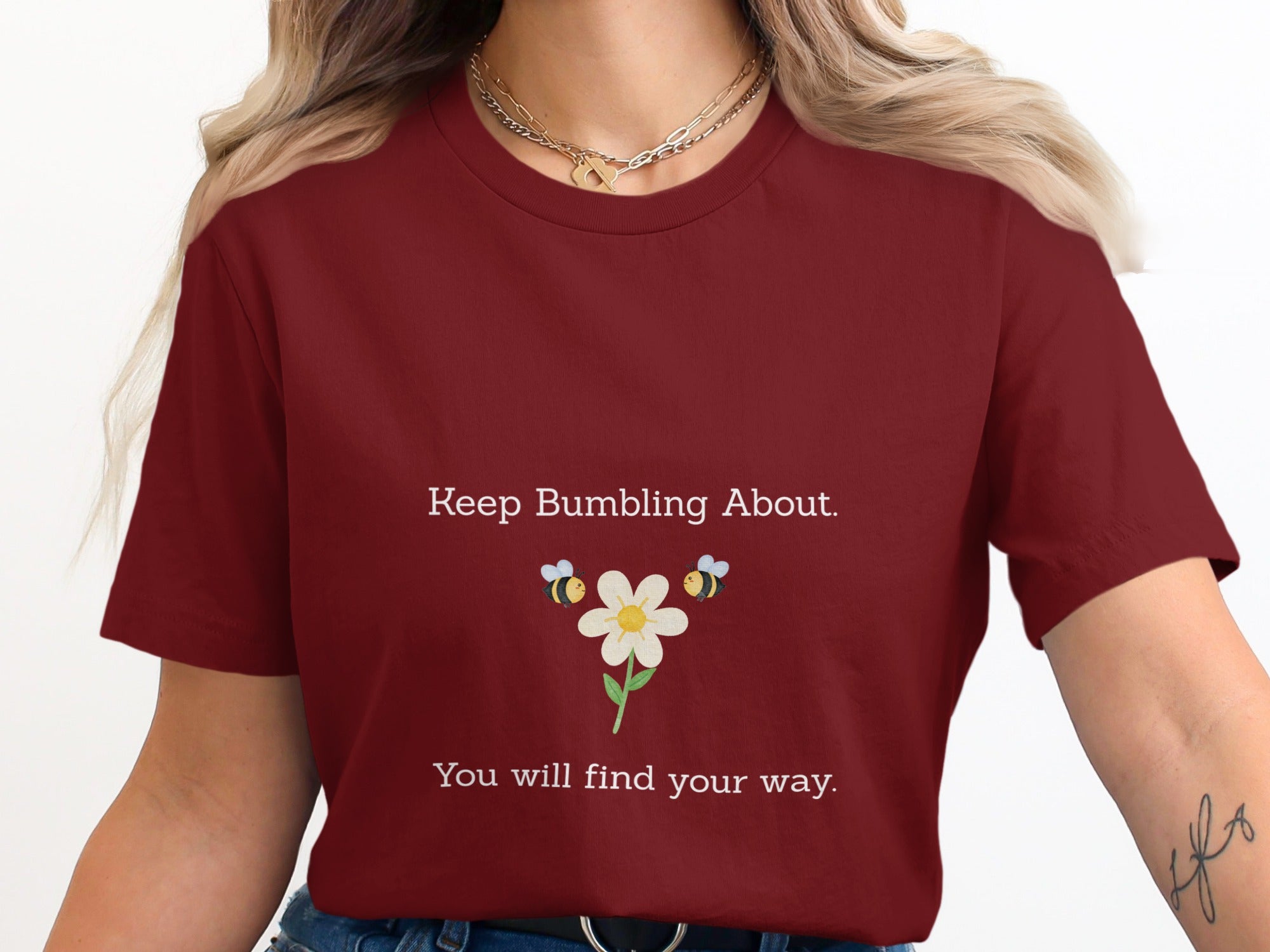 Maroon t-shirt with "Keep Bumbling About. You will find your way." and bees around a flower.