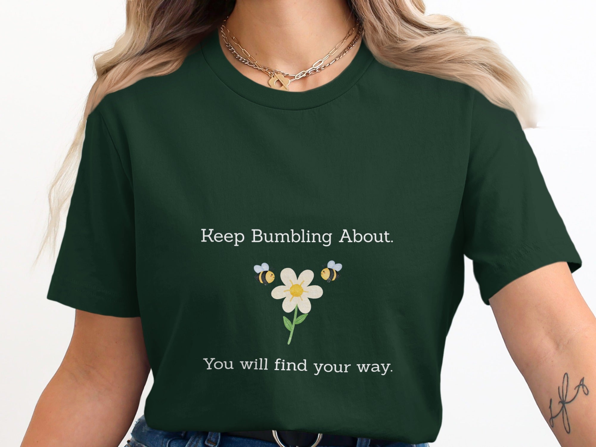Dark green t-shirt with "Keep Bumbling About. You will find your way." and two bees.